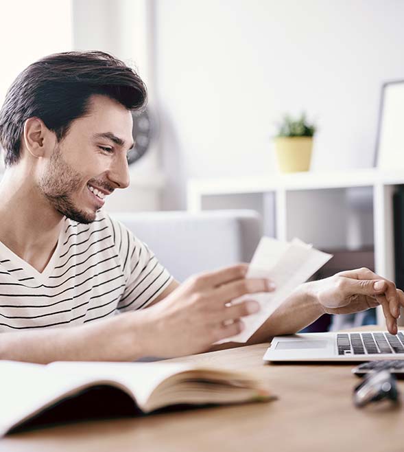 589x658px_Happy_man_paying_bills.jpg